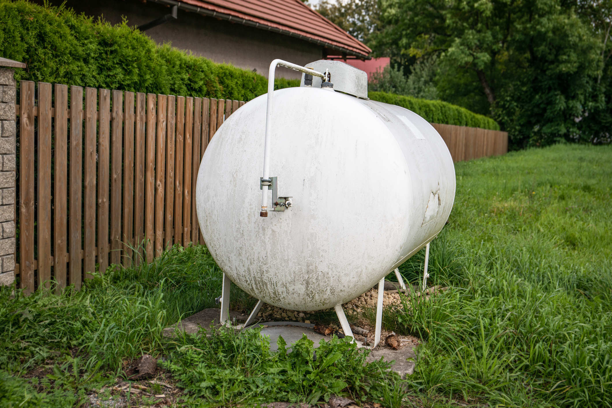 Gas tank for heating the house at the fence. Heating system.